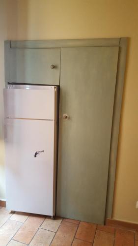 a kitchen with a white refrigerator in a room at Via della Posterna in Spoleto