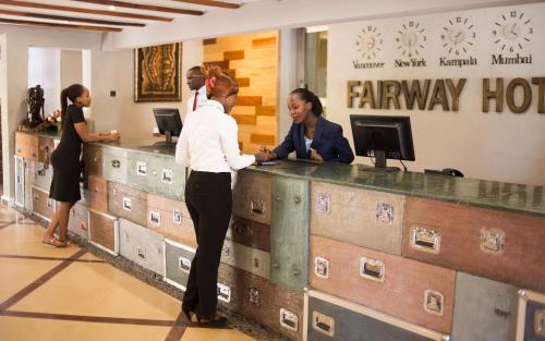 a group of women standing at a fairway hotel counter at Fairway Boutique Hotel - Kampala, Uganda in Kampala