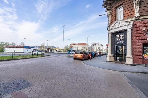 a street with a car parked next to a building at BpR THRILL Design Home with A/C in Budapest
