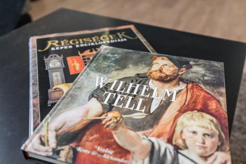 a book on a table with a painting on it at BpR THRILL Design Home with A/C in Budapest