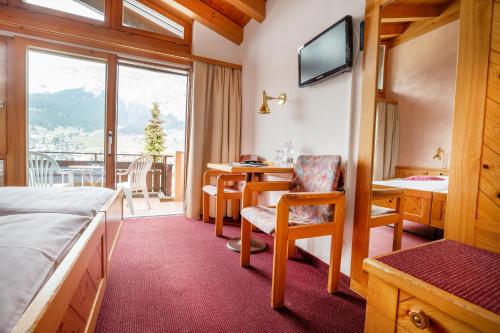 Postel nebo postele na pokoji v ubytování T3 Hotel Mira Val