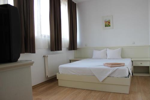 a bedroom with a white bed and a window at Banu Manta Apartments in Bucharest