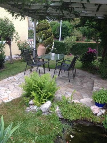 a patio with a table and chairs under a pergola at Instyle in Blankenbach