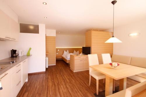 a kitchen and dining room with a table and chairs at Plarserhof in Lagundo