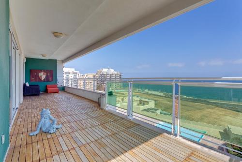 a balcony with a view of the ocean at Seafront Apartment in Sliema with Pool, Upmarket Complex in Sliema