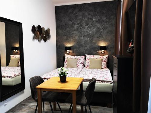 a bedroom with a bed and a table with chairs at Golden Key Apartments in Liberec