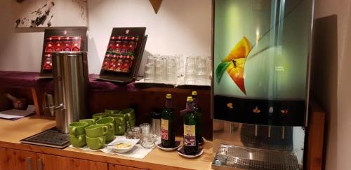 a bar with bottles of wine on a counter at AlpenParks Hotel Maria Alm in Maria Alm am Steinernen Meer