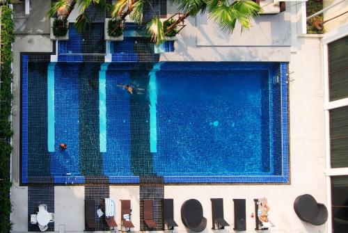 a swimming pool with two people swimming in it at Royal Princess Larn Luang - SHA Extra Plus in Bangkok