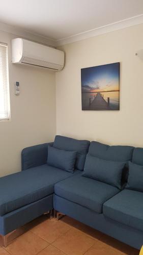 a living room with two blue couches in a room at Chalets on Frenchman in Albany