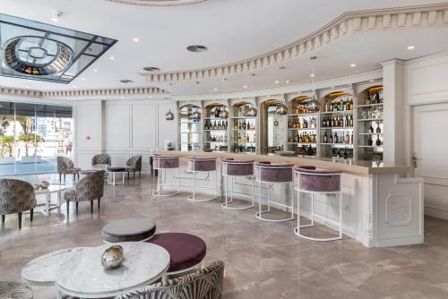 a bar in a room with tables and chairs at Boutique Hotel B51 in Marbella