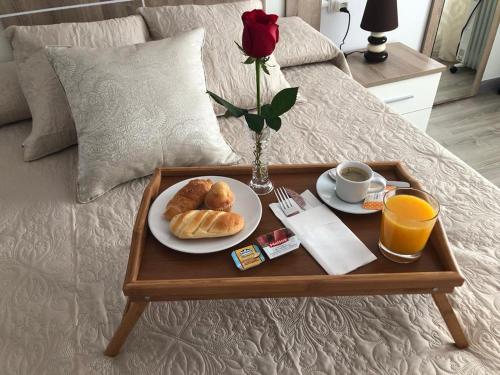 a tray with a plate of croissants and a cup of coffee at La CaSa De Su in Gijón