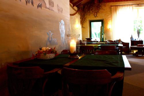 a candle sitting on a table in a restaurant at Hotel & Restaurant 'T Holt in Diepenheim