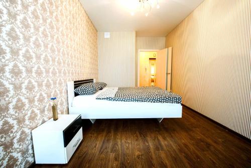 a bedroom with a bed and a tv in it at Гоголя,79 Двухкомнатные апартаменты in Ufa