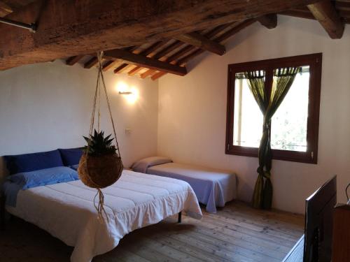 a bedroom with a bed and a window with a plant at Agriturismo Elianto in Ravenna