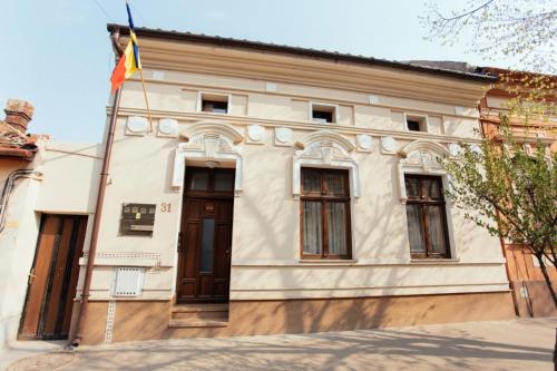 a building with a flag in front of it at Maniu 31 Apartments & Rooms in Oradea