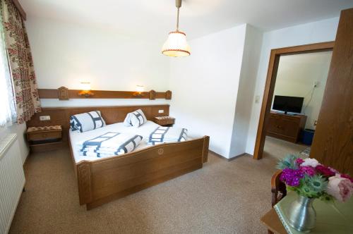 a bedroom with a bed and a large mirror at Haus Panorama in Lermoos