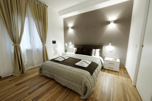 a bedroom with a bed and a dresser at Gocce di Girgenti - comfort suites in Agrigento