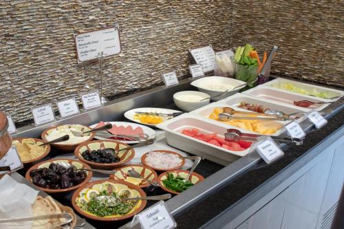 a buffet with many different types of food on a counter at Savoy Crest Hotel Apartments in Dubai