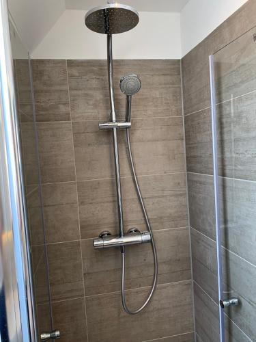 a shower with a shower head in a bathroom at Ferien Hus am Klüt in Hameln