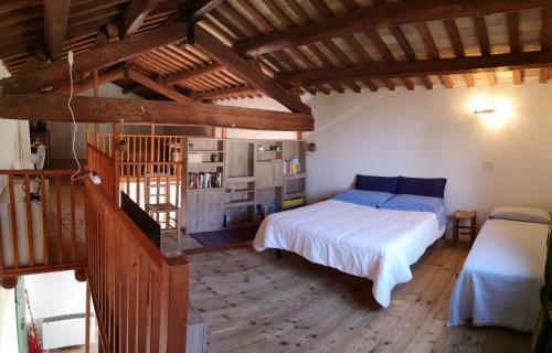 a bedroom with a bed and a wooden floor at Agriturismo Elianto in Ravenna