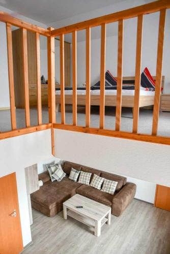 a living room with a couch and a bed at Landgasthof Benjamin in Treffelstein
