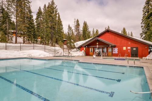 a swimming pool in front of a red building at Granlibakken Elegance in Tahoe City