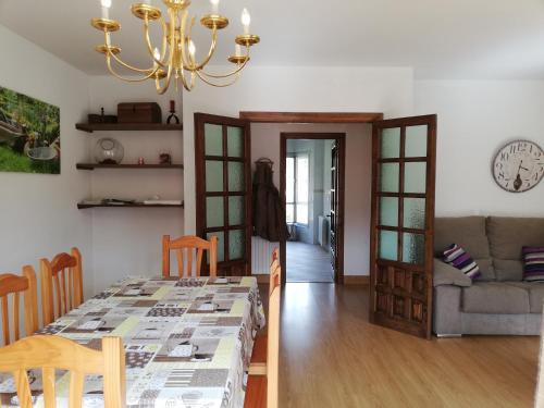 a dining room and living room with a dining table at Apartamento Peñalabra in Potes