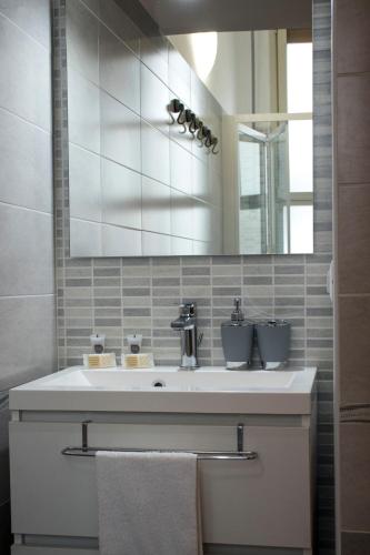 a bathroom with a sink and a mirror at Peter's House in Letojanni