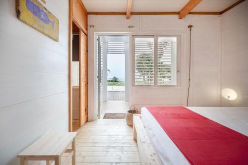 a bedroom with a bed and a bench and a window at Maresia Rooms in Procida