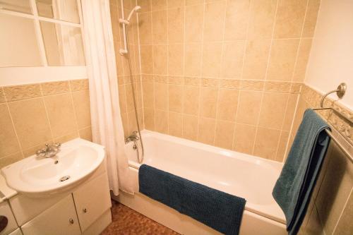 a bathroom with a sink and a tub and a toilet at Ideal Lodgings in Bury - Fairfield in Bury