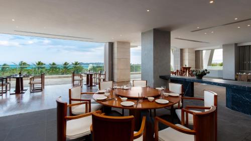 a dining room with a table and chairs at The Mangrovetree Sanya Resort in Sanya