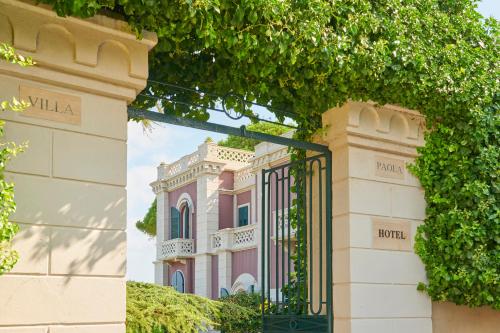 a pink building with a gate in front of it at Villa Paola in Tropea