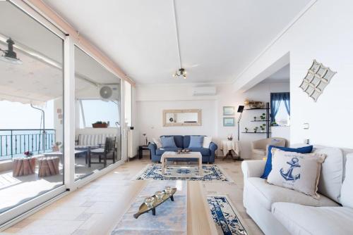 a living room with a couch and a table at Apartment with marina view in Thessaloniki