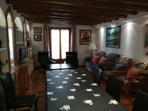a living room with a table and a couch at Casa Murillo in Boltaña