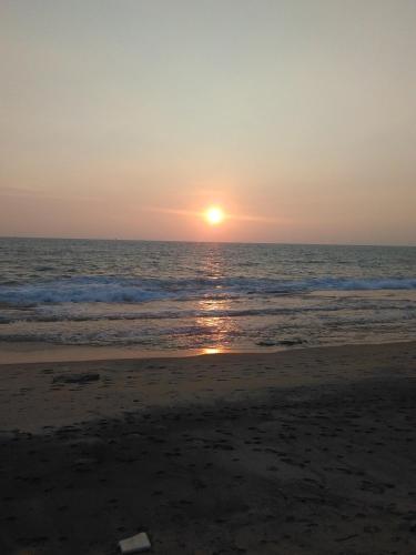 a sunset on the beach with the ocean at VILLA ARIANNA in Wattala