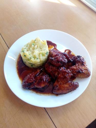 a plate of food with meat and potatoes on a table at Na Losenici in Nicov
