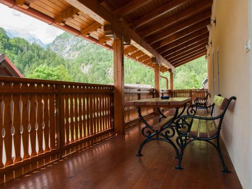 a balcony with a table and chairs on it at Apartments and rooms Nataša 1 in Trenta