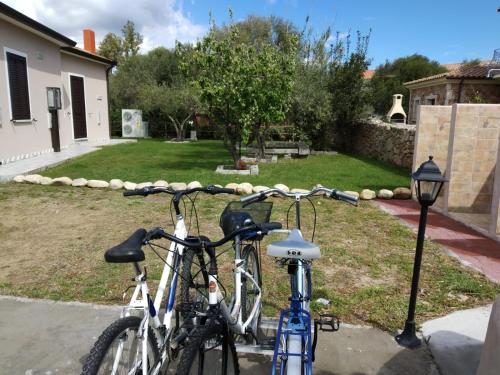 two bikes parked next to each other in a yard at B&B LE ISOLE in San Teodoro