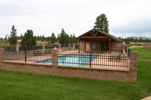 a fence around a pool with a house at Bryce Canyon Pines in Bryce Canyon