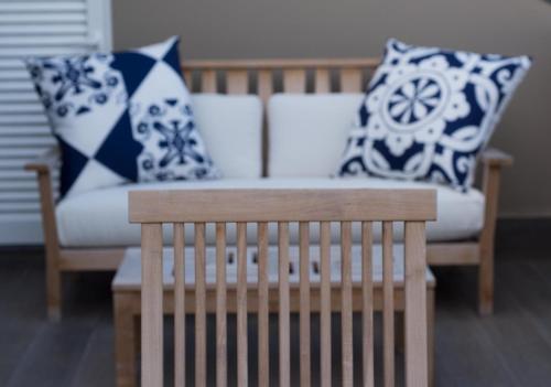 a living room with a couch and pillows at Hotel Casa Hintze Ribeiro in Ponta Delgada