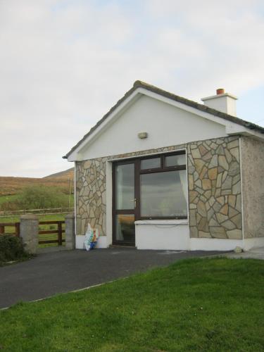 a small house with a large window on it at Sea View Chalet Kilsallagh Westport Co Mayo in Kilsallagh