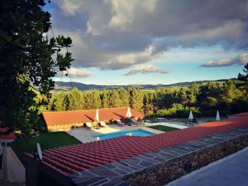 an aerial view of a house with a swimming pool at Quinta dos Morangueiros in Armamar
