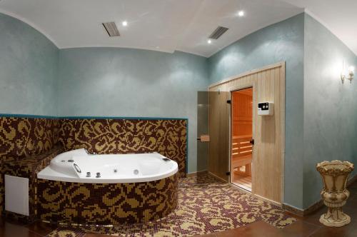 a bathroom with a tub in the middle of the room at Purple Star Apartments in Saints Constantine and Helena