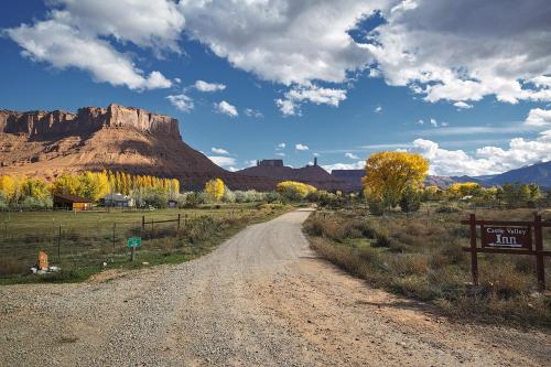 a dirt road in the desert with a mountain in the background at Castle Valley Inn in Moab