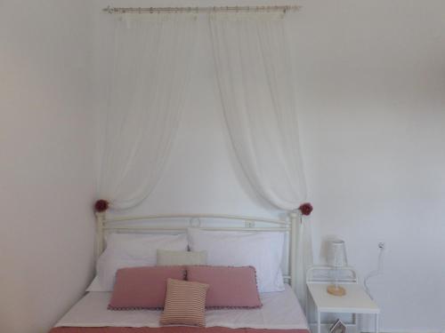 a bedroom with a white bed with a white canopy at Teo 3 in Gouves