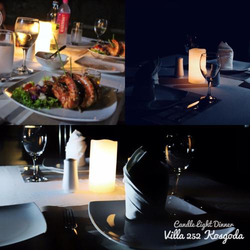 a table with a plate of food and wine glasses at Villa 252 Kosgoda in Kosgoda