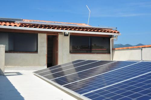 a house with a lot of solar panels on the roof at CANTO DA ARVORE 1 in Arraial do Cabo
