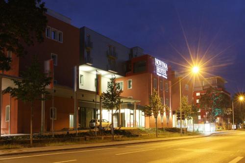a building on a city street at night at Novina Hotel Tillypark in Nürnberg