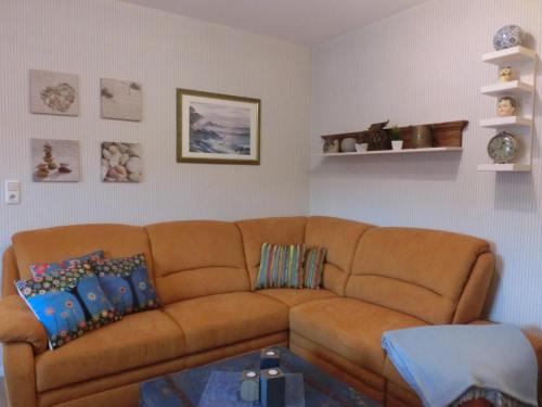 a living room with a brown couch and a table at Villa Harmonie in Lohme