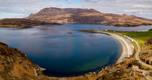 uma grande massa de água com uma montanha ao fundo em Tigh na Mara em Ullapool